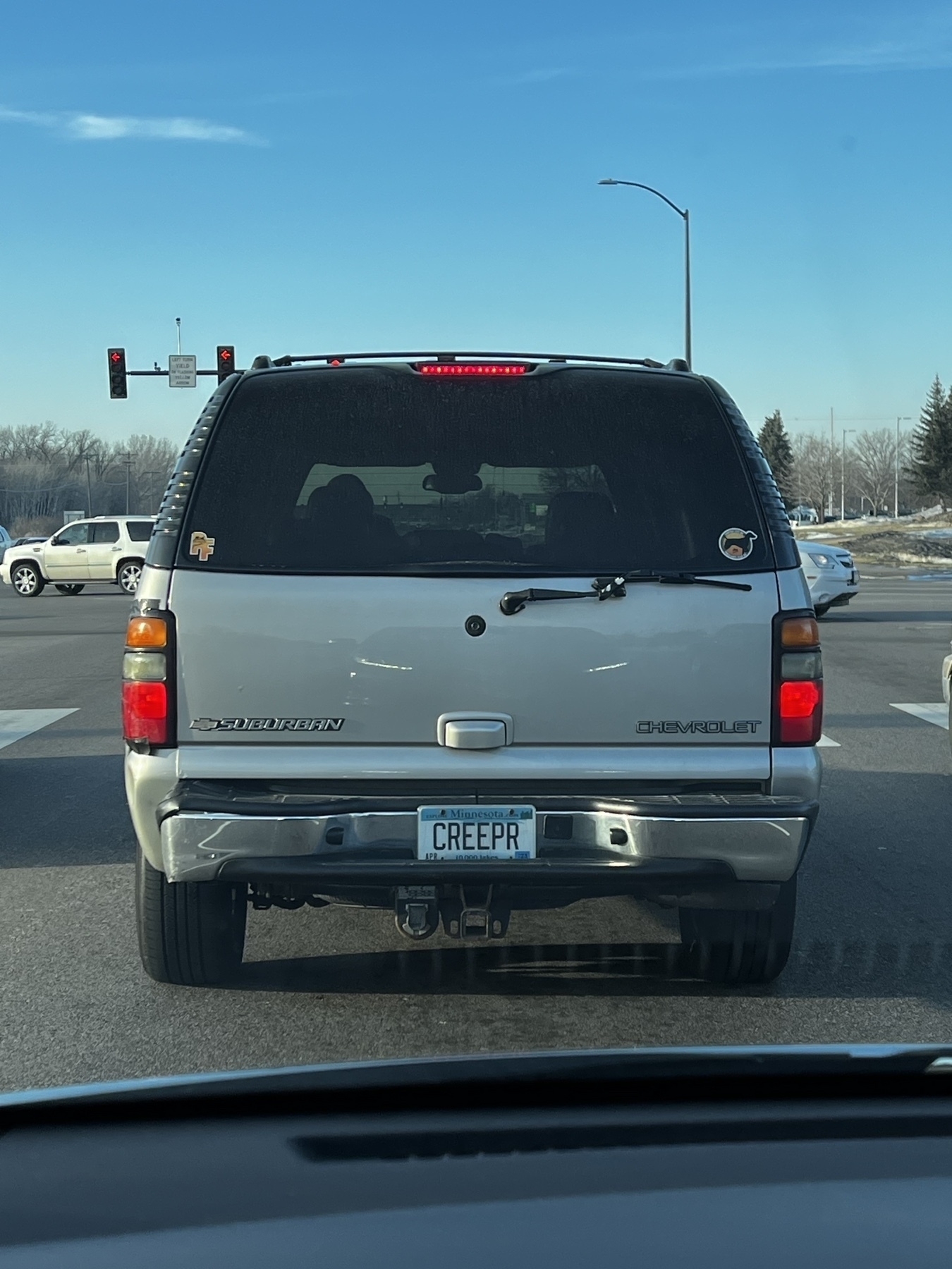A Chevy Suburban SUV with the license plate CREEPR